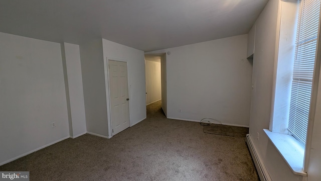 unfurnished bedroom with baseboard heating and light colored carpet