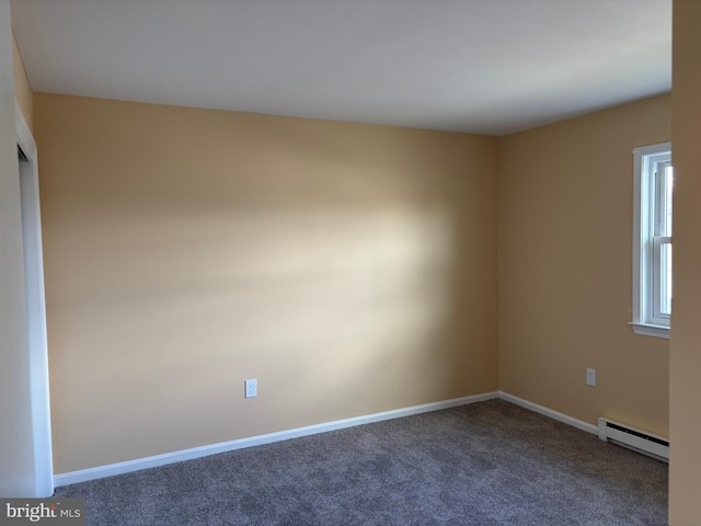 carpeted empty room with a baseboard radiator