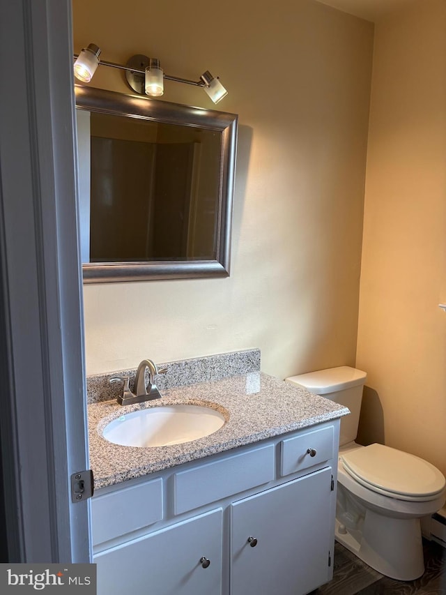 bathroom featuring vanity and toilet