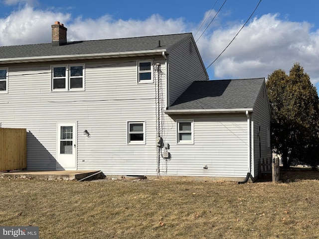 rear view of property with a yard