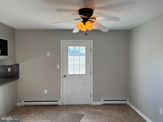 entryway with a baseboard heating unit and ceiling fan