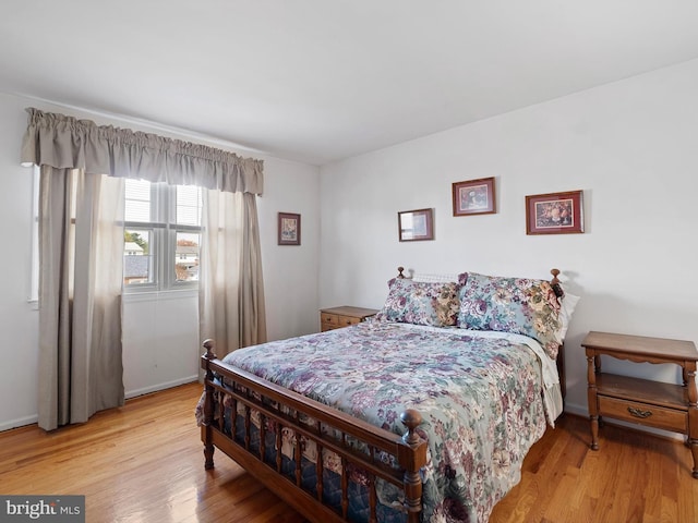 bedroom featuring baseboards and light wood-type flooring
