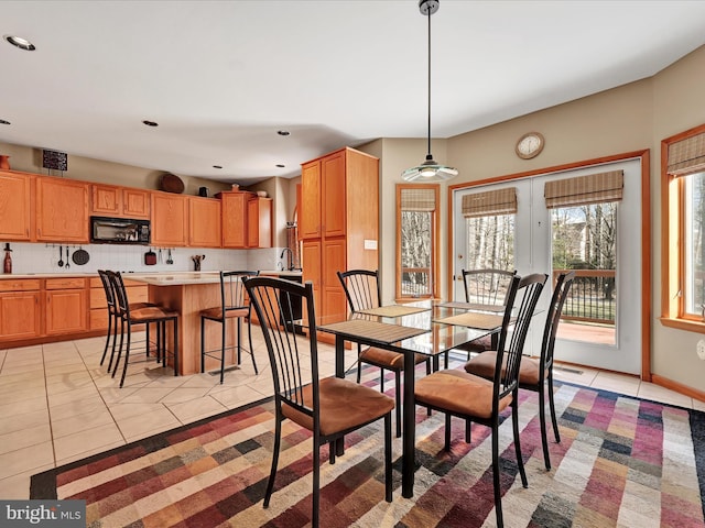 dining space with sink and light tile patterned floors