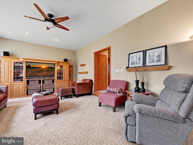 carpeted living room with ceiling fan