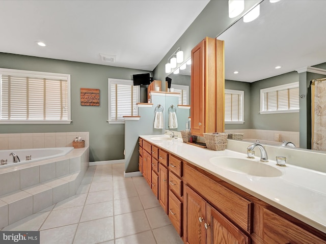 bathroom featuring vanity, tiled tub, and tile patterned floors