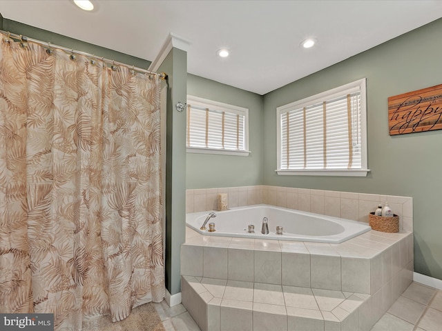 bathroom featuring tile patterned flooring and tiled bath