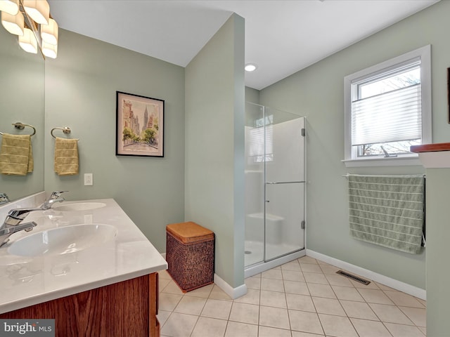 bathroom featuring tile patterned floors, vanity, and a shower with shower door