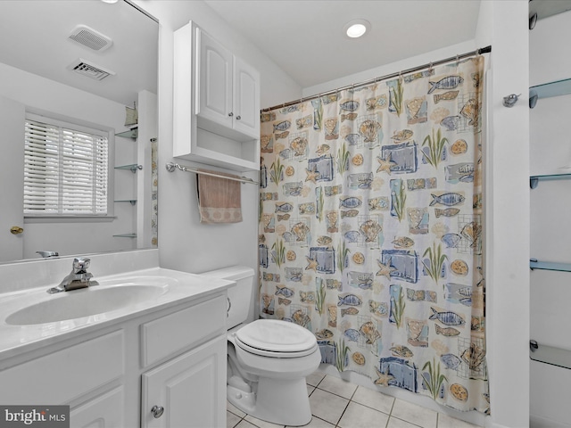 bathroom with walk in shower, tile patterned floors, toilet, and vanity