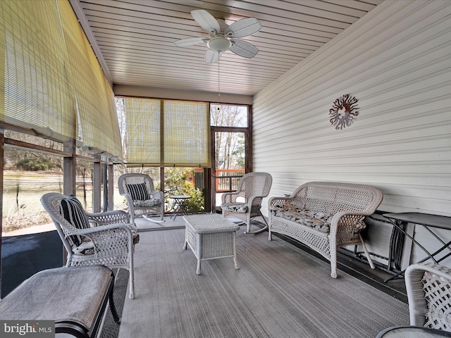 sunroom featuring ceiling fan