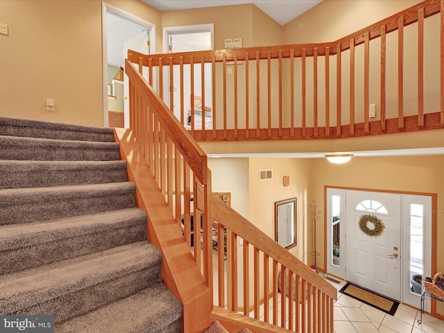 stairway with tile patterned floors