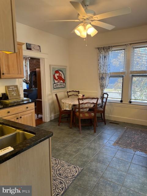 tiled dining room with ceiling fan