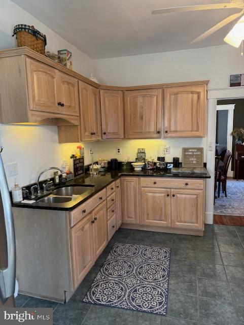 kitchen featuring ceiling fan, sink, and light brown cabinets