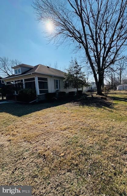 view of home's exterior with a yard