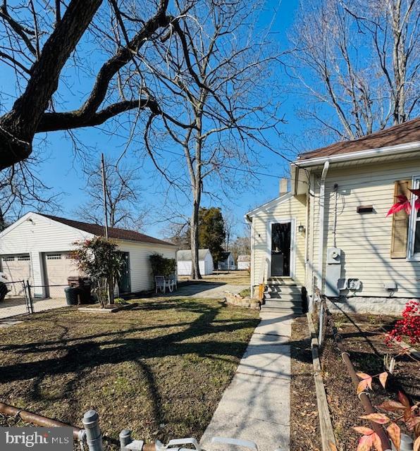 view of side of home with a lawn