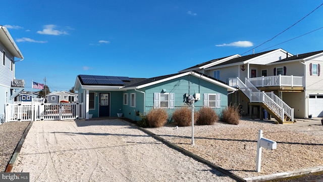 view of front facade featuring solar panels