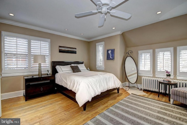 bedroom with ornamental molding, radiator heating unit, ceiling fan, and light hardwood / wood-style flooring