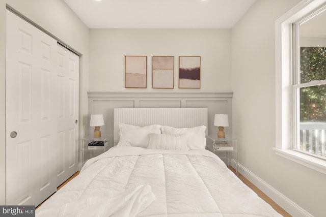 bedroom featuring baseboards and wood finished floors