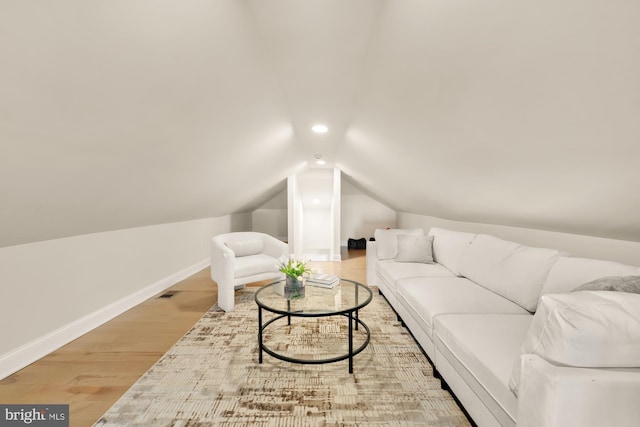 living area featuring lofted ceiling, recessed lighting, baseboards, and wood finished floors