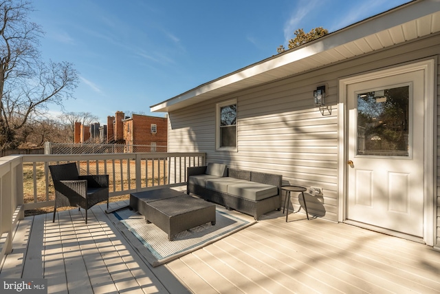 wooden terrace featuring fence and an outdoor living space