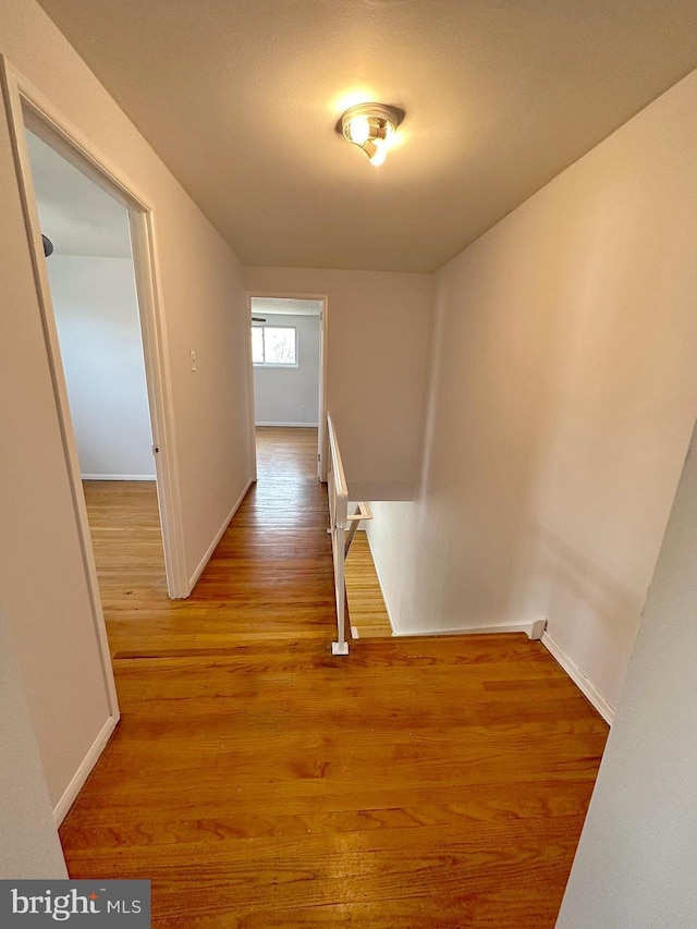 corridor with light hardwood / wood-style floors