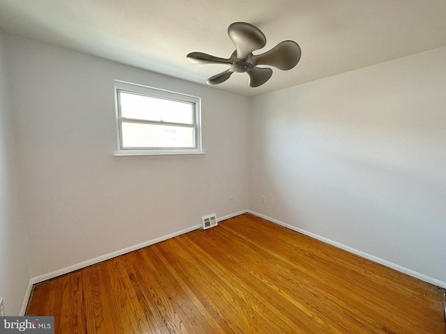 empty room with wood-type flooring and ceiling fan