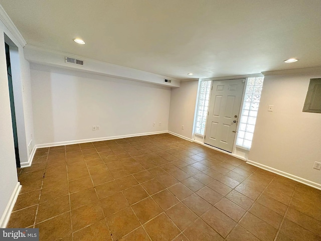 interior space with crown molding and dark tile patterned flooring