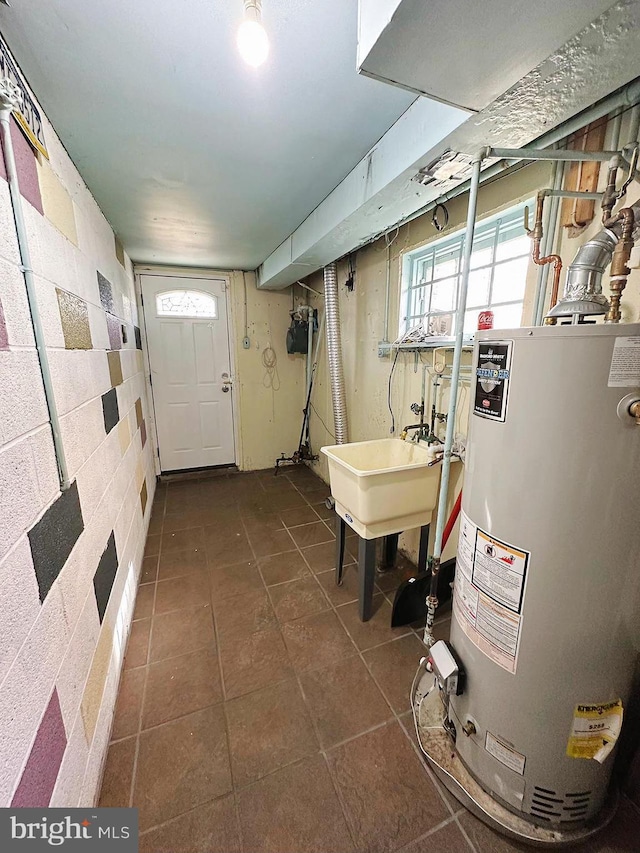 interior space with gas water heater and sink