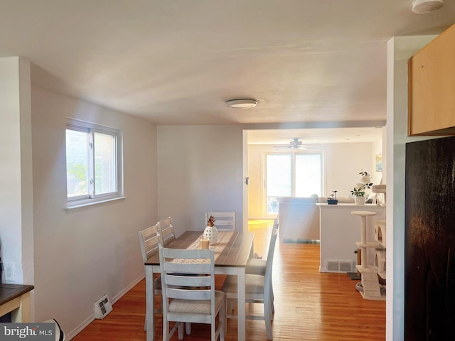 dining area with ceiling fan, wood-type flooring, and a wealth of natural light