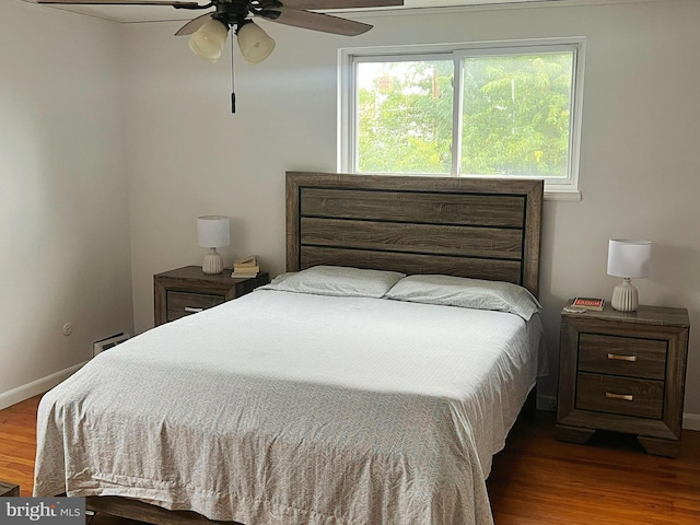 bedroom with ceiling fan and hardwood / wood-style floors