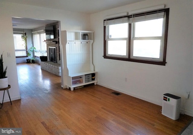 interior space with hardwood / wood-style floors and a fireplace