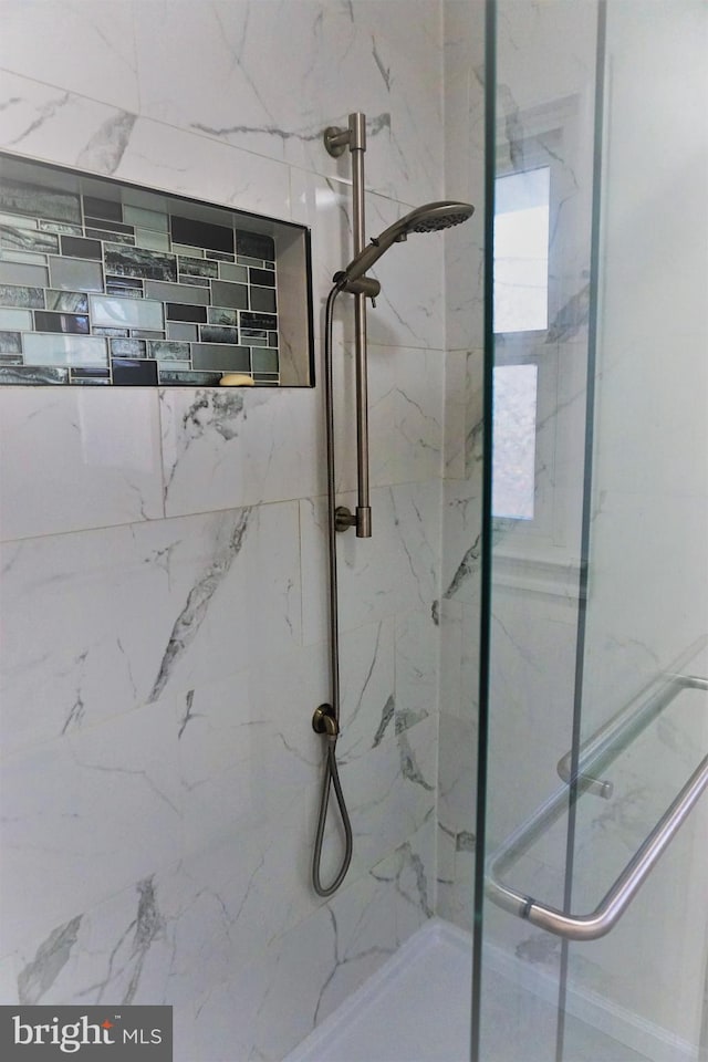 bathroom with a shower with shower door