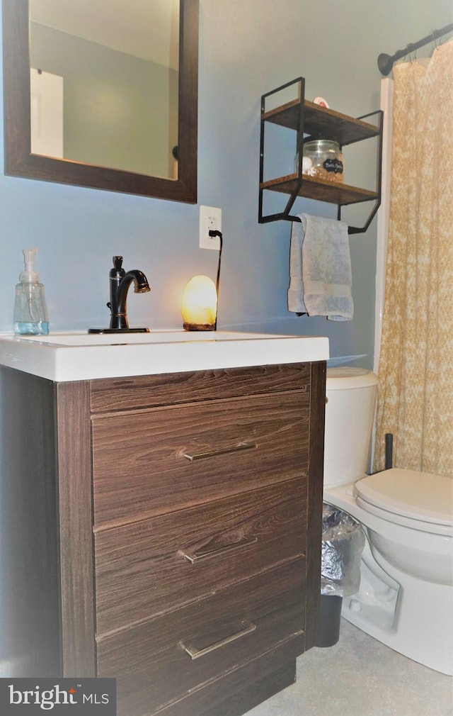 bathroom featuring vanity and toilet