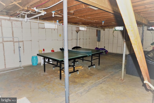 game room with electric panel and concrete floors