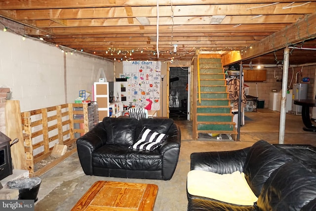 basement featuring water heater and washer / clothes dryer