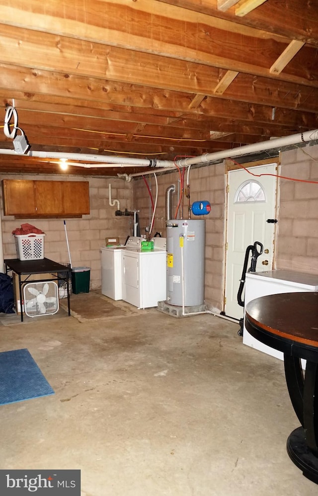 garage featuring washer and clothes dryer and water heater