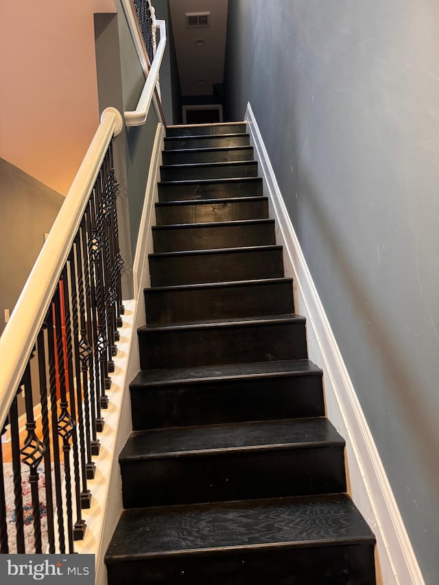 staircase with wood-type flooring