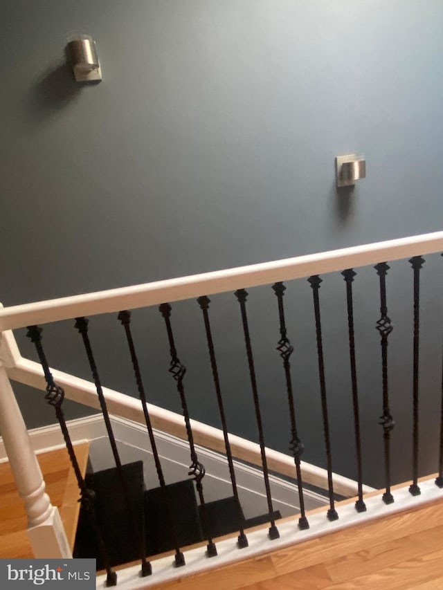 stairway featuring hardwood / wood-style flooring