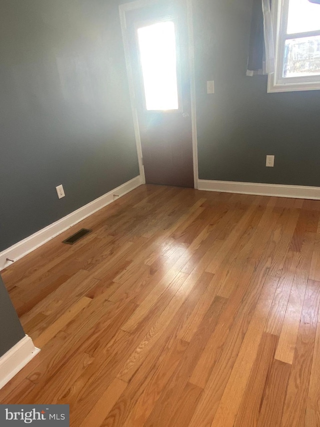 unfurnished room featuring light hardwood / wood-style flooring and a wealth of natural light