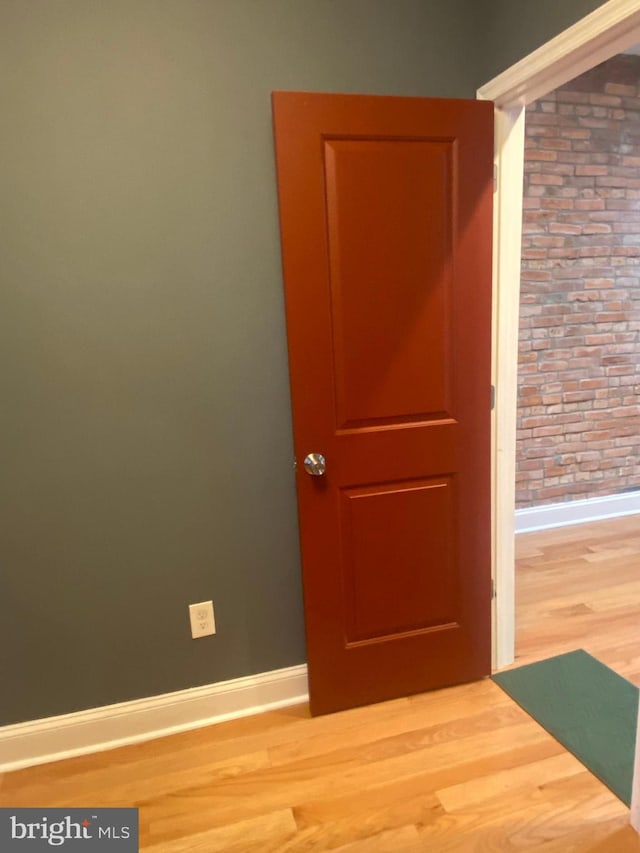 spare room featuring wood-type flooring