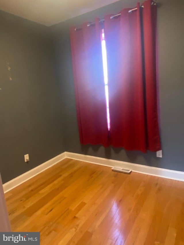 unfurnished room featuring hardwood / wood-style floors