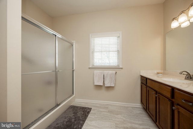 bathroom featuring an enclosed shower and vanity