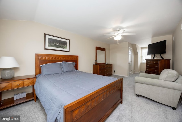 carpeted bedroom featuring ceiling fan and vaulted ceiling