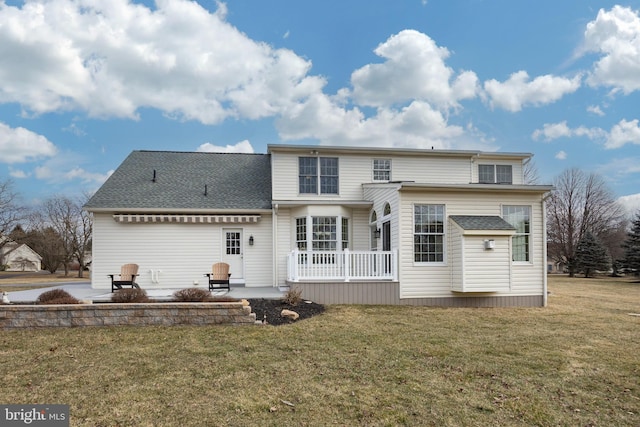 back of property featuring a patio and a yard