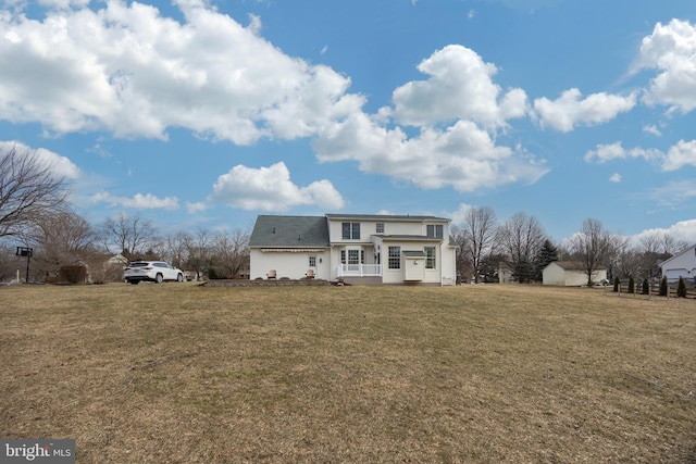 rear view of house with a yard