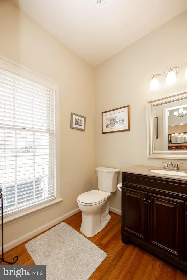 bathroom featuring hardwood / wood-style flooring, vanity, and toilet