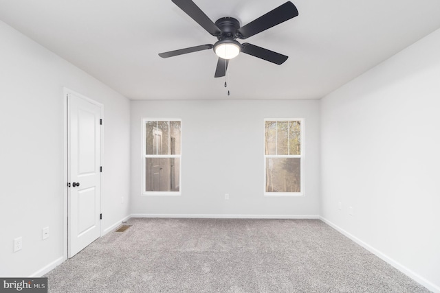 carpeted spare room with ceiling fan