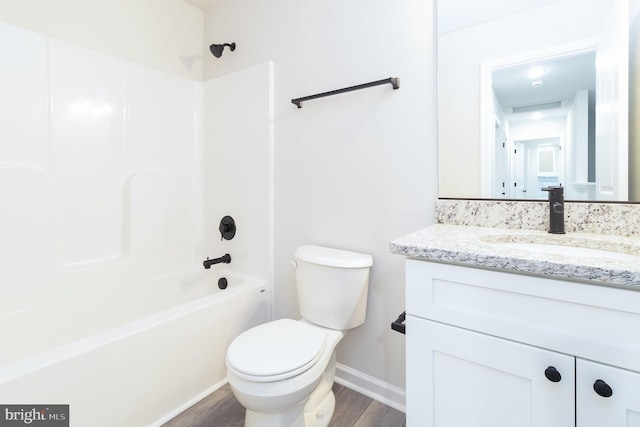 full bathroom with vanity, shower / bathing tub combination, hardwood / wood-style floors, and toilet