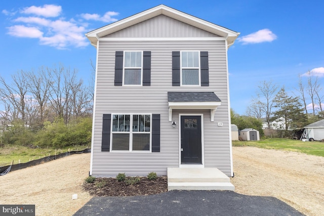 view of front of house with a storage unit