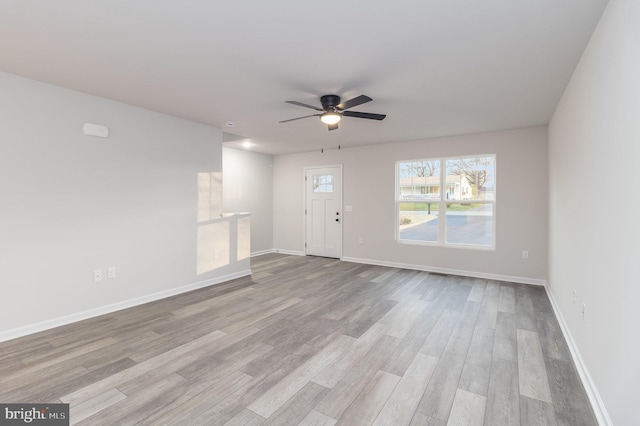 unfurnished living room featuring ceiling fan and light wood-type flooring