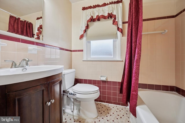 full bathroom with shower / bathtub combination with curtain, vanity, toilet, and tile walls